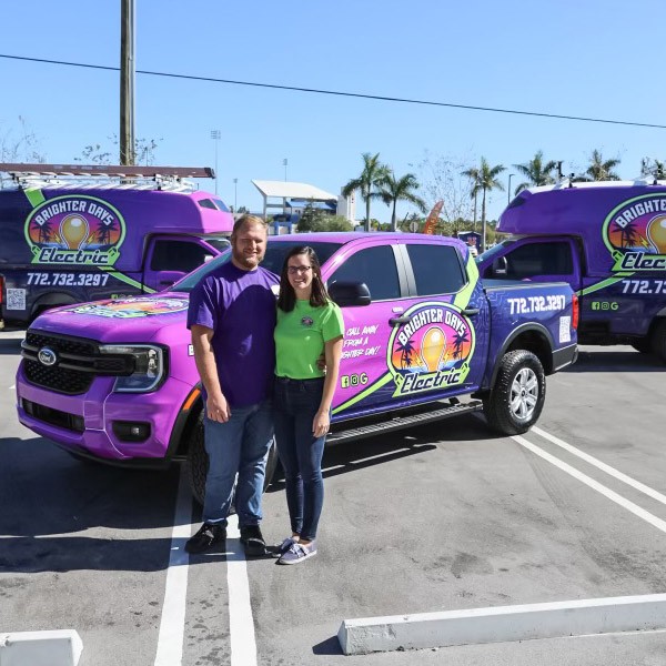 Electricians Standing Beside Their Vehicles in Palm City, FL
