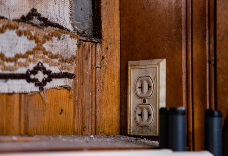 Old Electrical Outlet on a Worn Wooden Wall in St. Port Lucie, FL